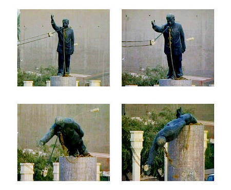 Marines Staff Sgt. Nick Popadich stood atop his tank, saddam's huge statue appeared in the background just before destroying it, central Baghdad, April 9, 2003.